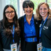 President Mantella taking photo with two event guests